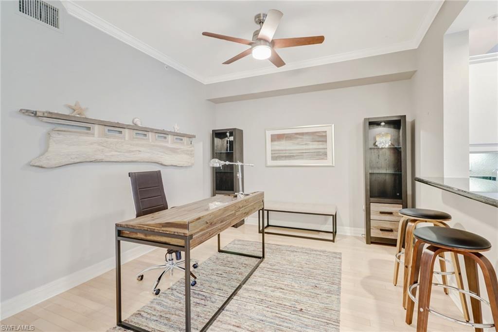 401 Bayfront Place, Unit 3303 Naples, FL 34102 - Photo 3 of 22 a living room with furniture a flat screen tv and a table