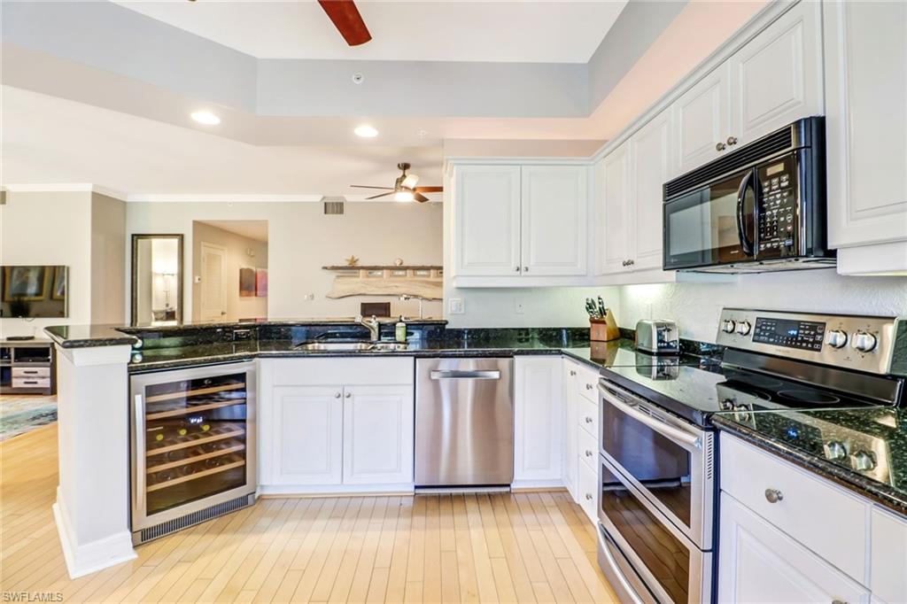 401 Bayfront Place, Unit 3303 Naples, FL 34102 - Photo 6 of 22 a kitchen with stainless steel appliances white cabinets and a stove top oven