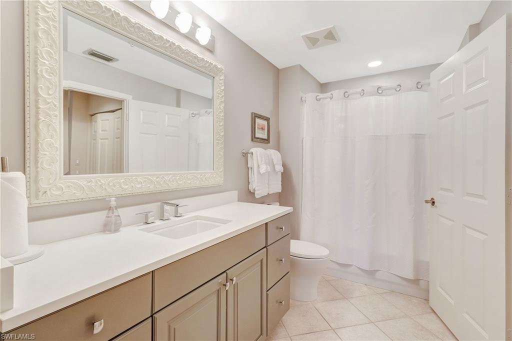 401 Bayfront Place, Unit 3303 Naples, FL 34102 - Photo 10 of 22 a bathroom with a sink toilet double vanity and tub