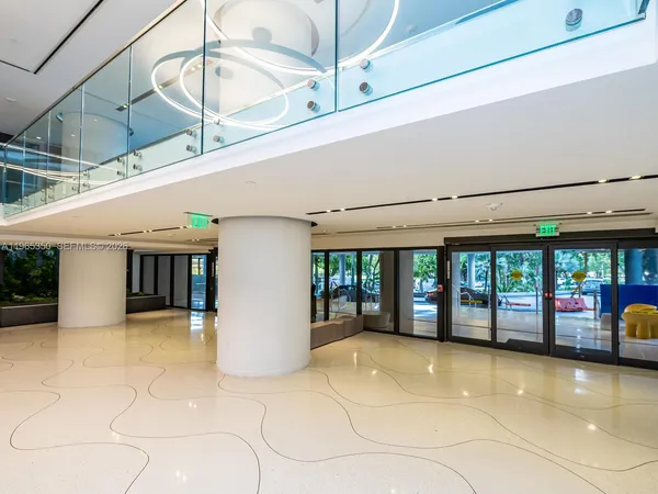 a view of a livingroom with furniture and mirror
