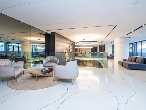 a living room with furniture floor to ceiling windows and a floor to ceiling window