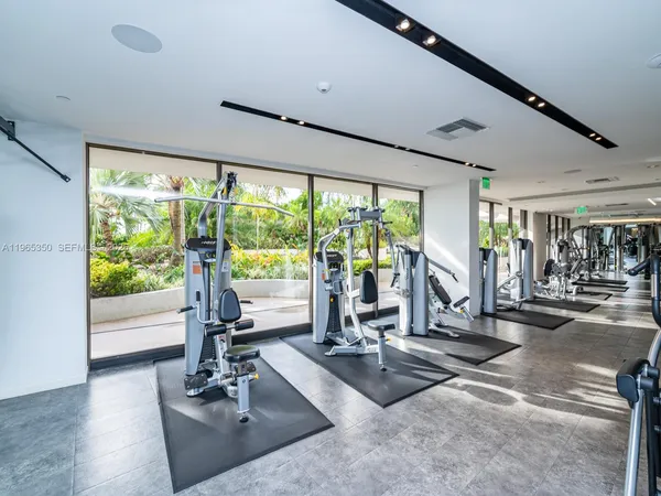 a living room with fireplace furniture and a large window