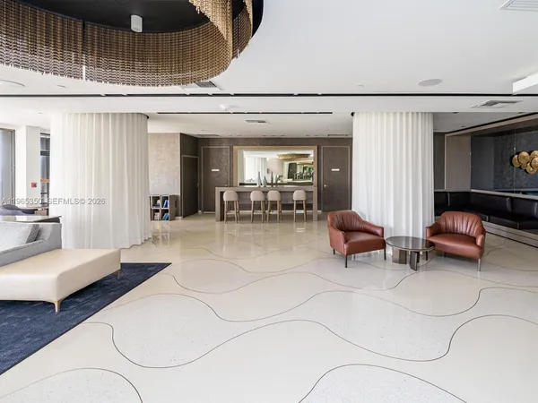 a living room with a floor to ceiling window and wooden floor