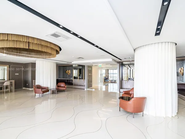 a view of a livingroom with furniture and a ceiling fan