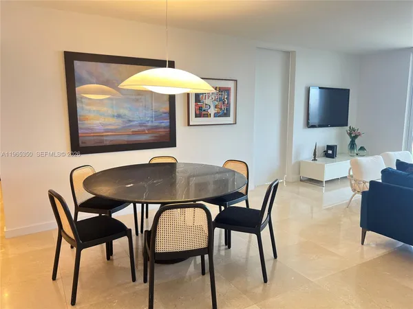 a view of a dining room with furniture and a flat screen tv
