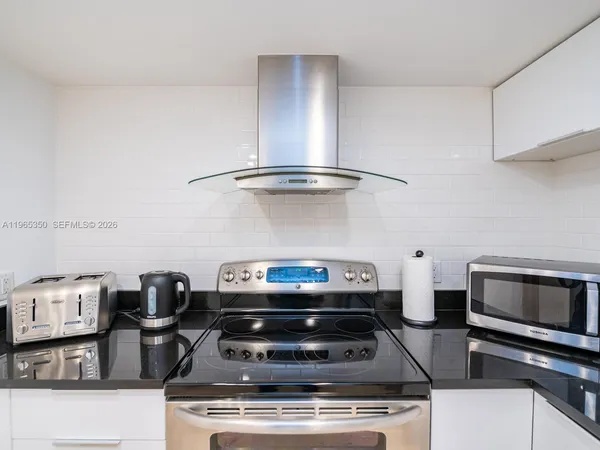 a stove top oven sitting inside of a kitchen