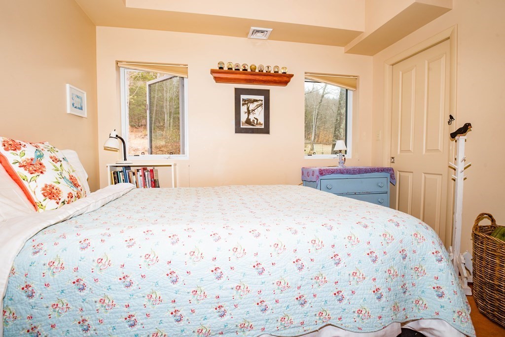 113 Indian Hollow Road Chesterfield, MA 01012 - Photo 15 of 42 a bedroom with a bed and wooden floor