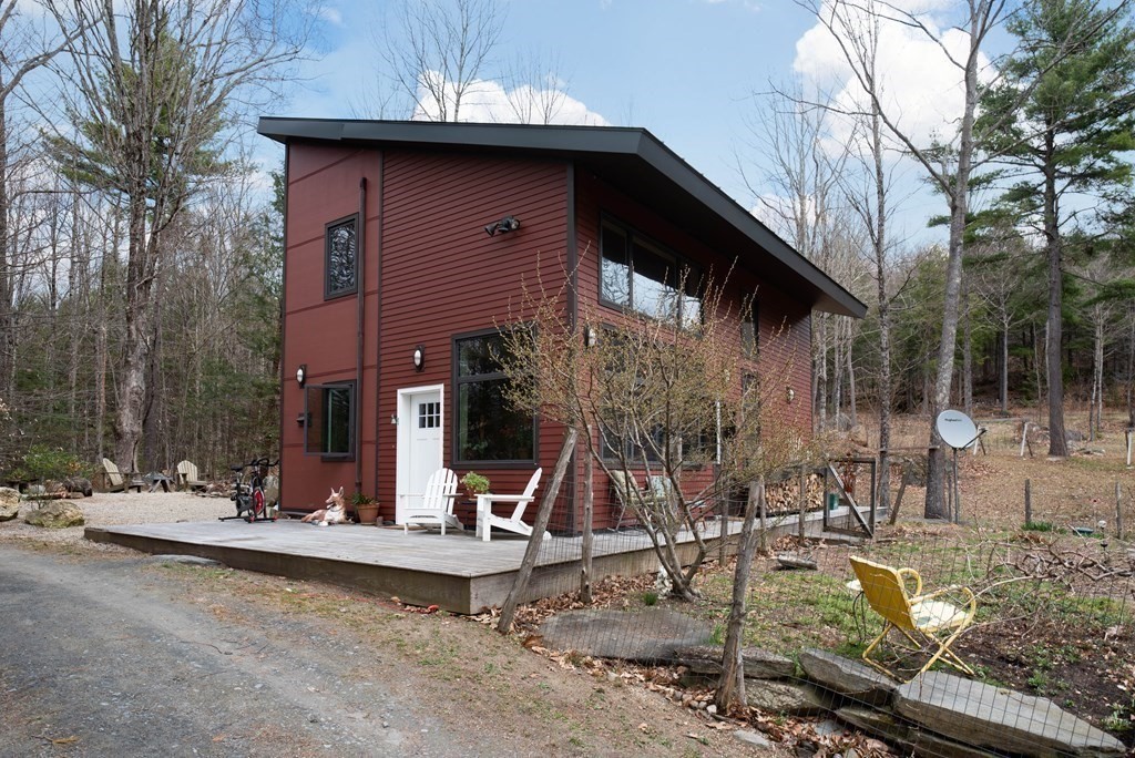 113 Indian Hollow Road Chesterfield, MA 01012 - Photo 2 of 42 a view of a house with backyard water fountain and sitting area