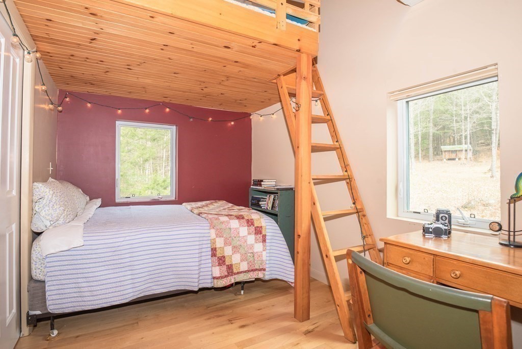 113 Indian Hollow Road Chesterfield, MA 01012 - Photo 22 of 42 a bedroom with a bed and a large window