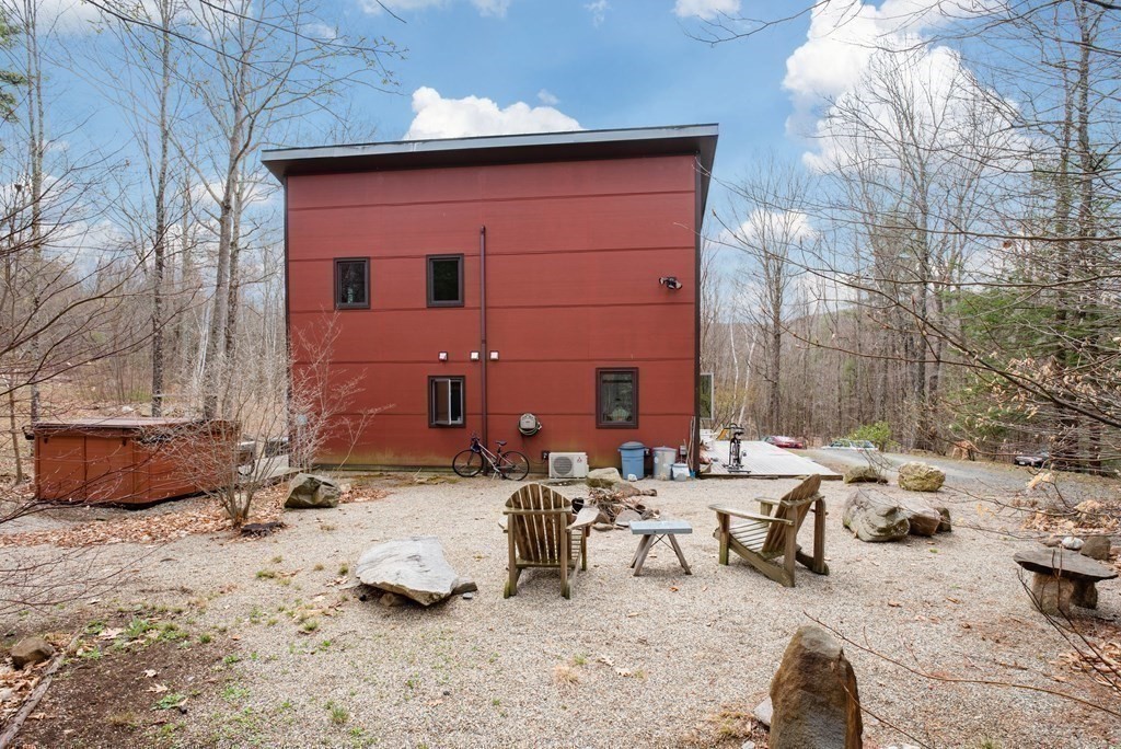 113 Indian Hollow Road Chesterfield, MA 01012 - Photo 36 of 42 a backyard of a house with table and chairs
