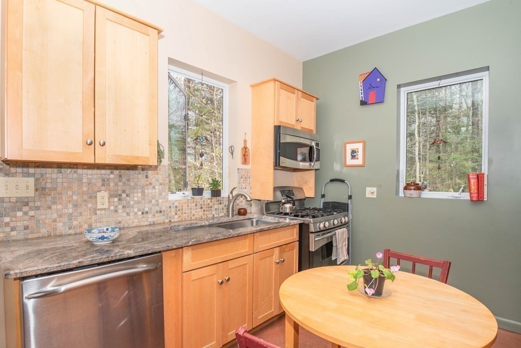 113 Indian Hollow Road Chesterfield, MA 01012 - Photo 5 of 42 a kitchen with a sink stove and microwave