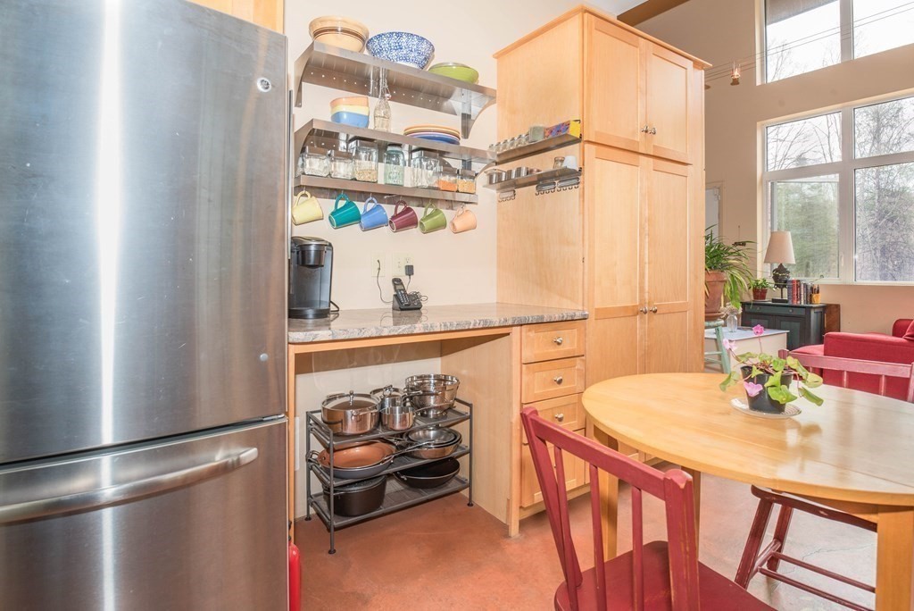 113 Indian Hollow Road Chesterfield, MA 01012 - Photo 6 of 42 a kitchen with stainless steel appliances granite countertop a sink a refrigerator and a dining table view