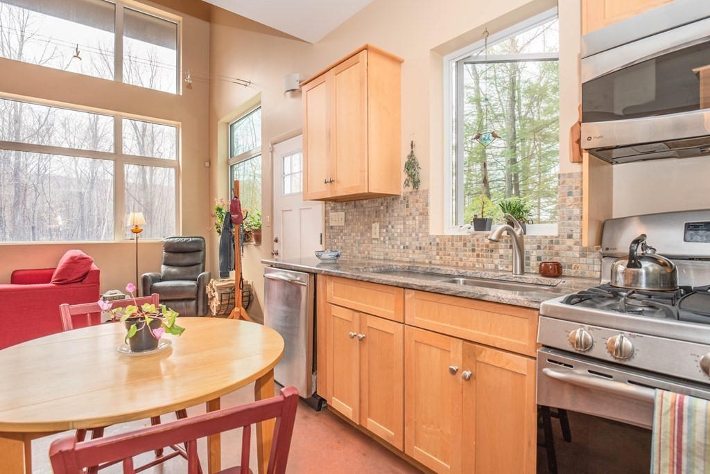 113 Indian Hollow Road Chesterfield, MA 01012 - Photo 8 of 42 a kitchen with stainless steel appliances granite countertop a stove a sink and white cabinets