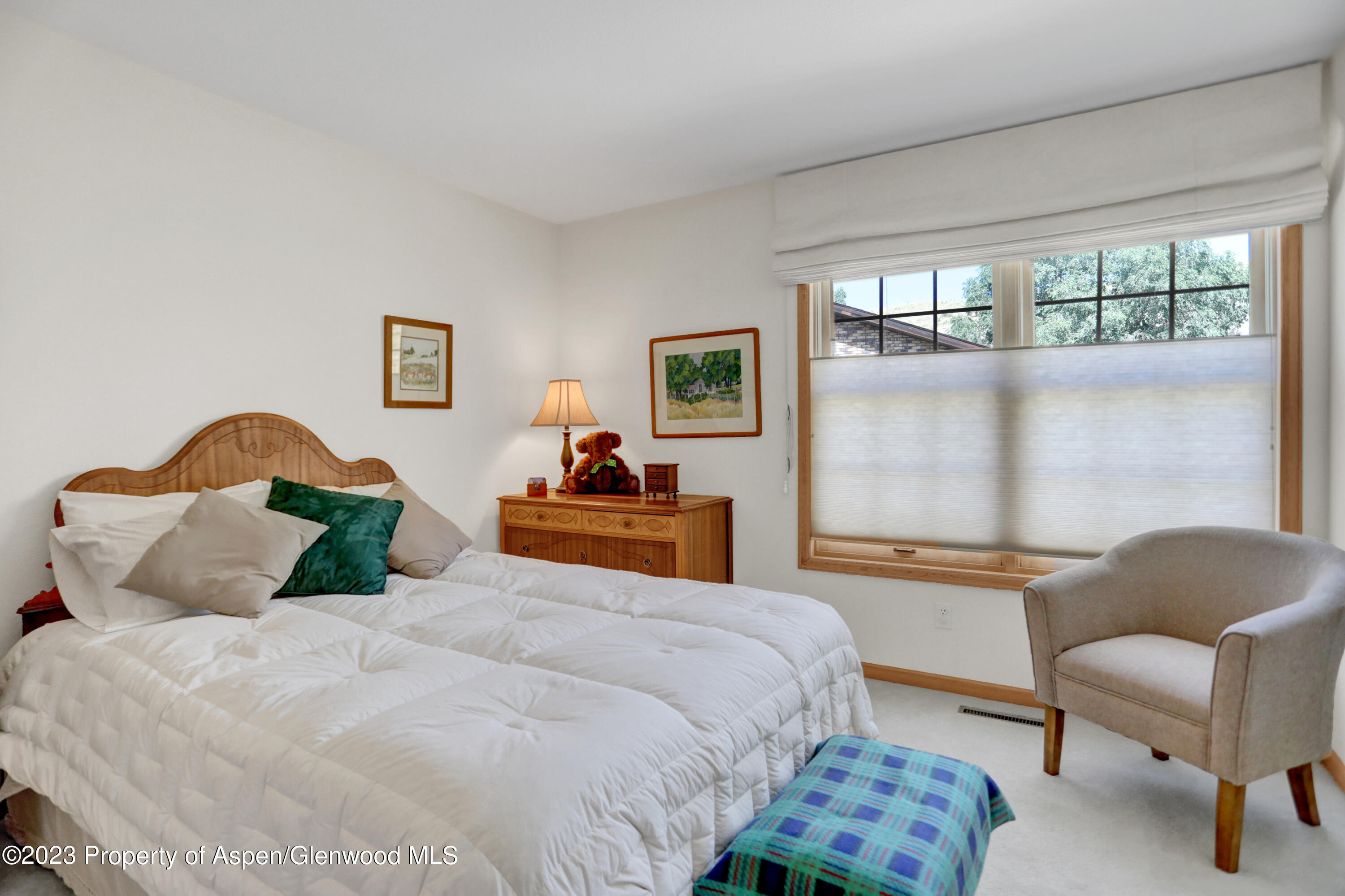 921 Alta Vista Drive Craig, CO 81625 - Photo 23 of 55 a bedroom with a bed and a chair