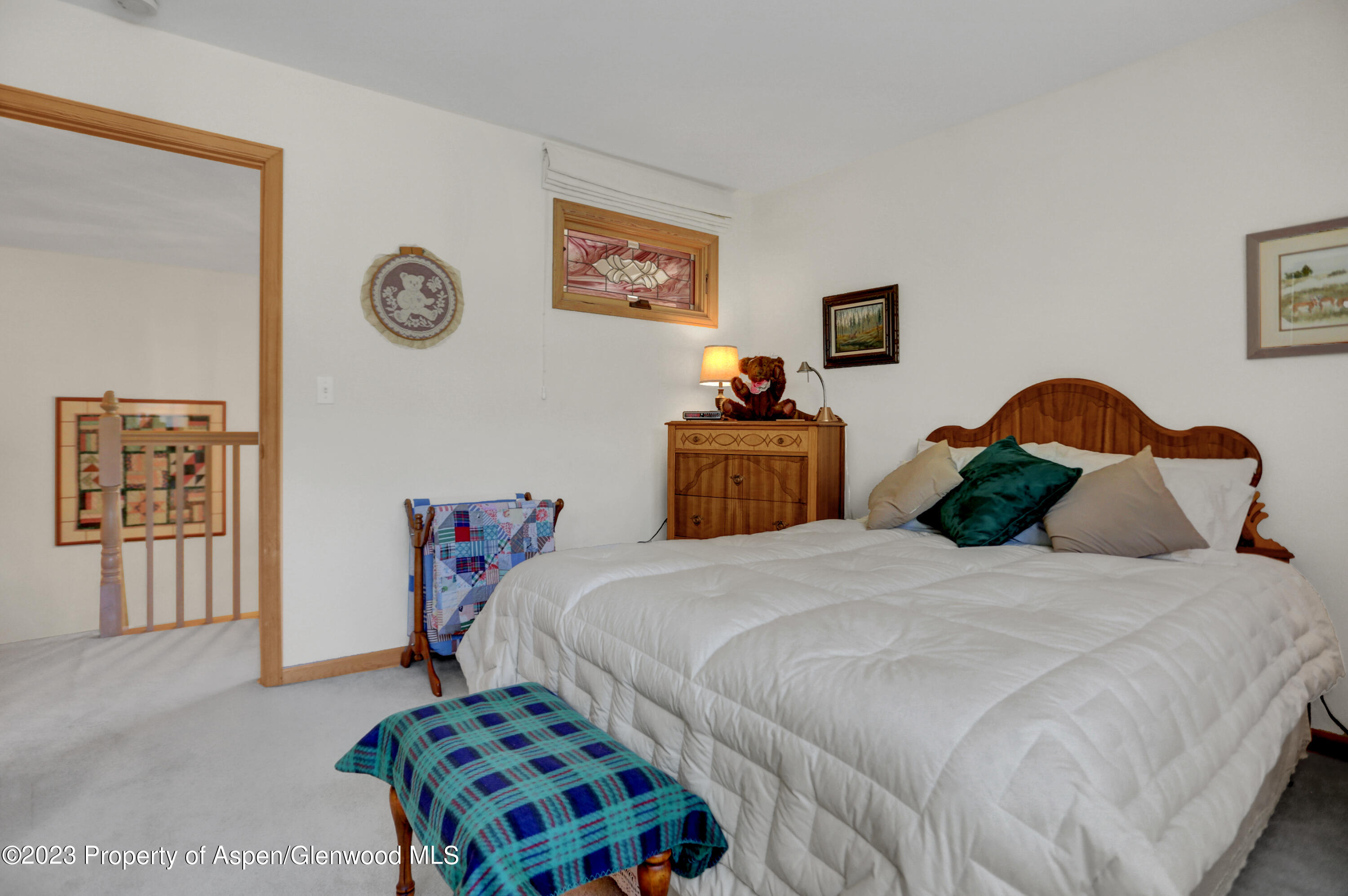 921 Alta Vista Drive Craig, CO 81625 - Photo 25 of 55 a bedroom with a bed and a lamp on dresser