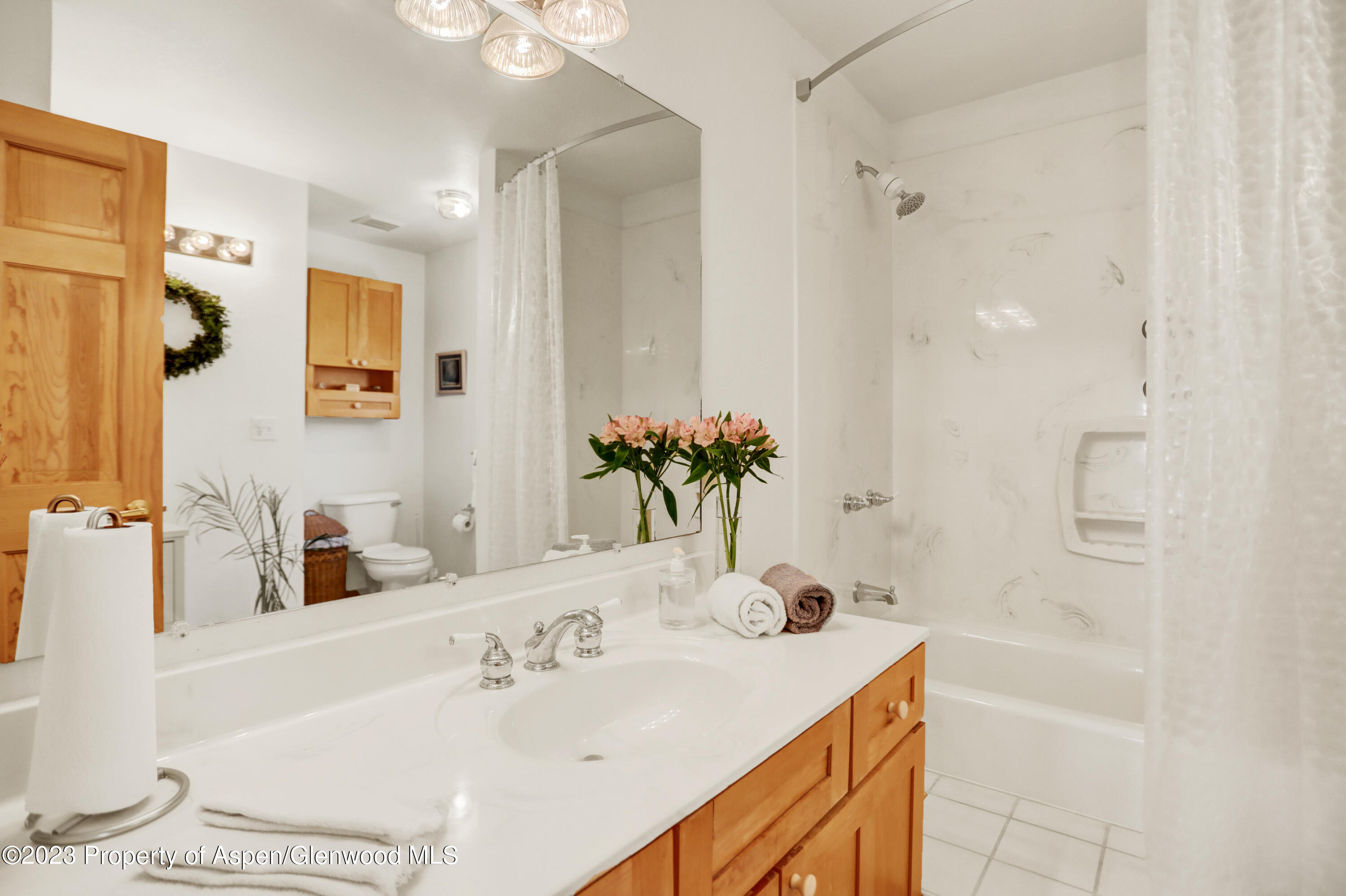 921 Alta Vista Drive Craig, CO 81625 - Photo 31 of 55 a bathroom with a granite countertop sink and a mirror