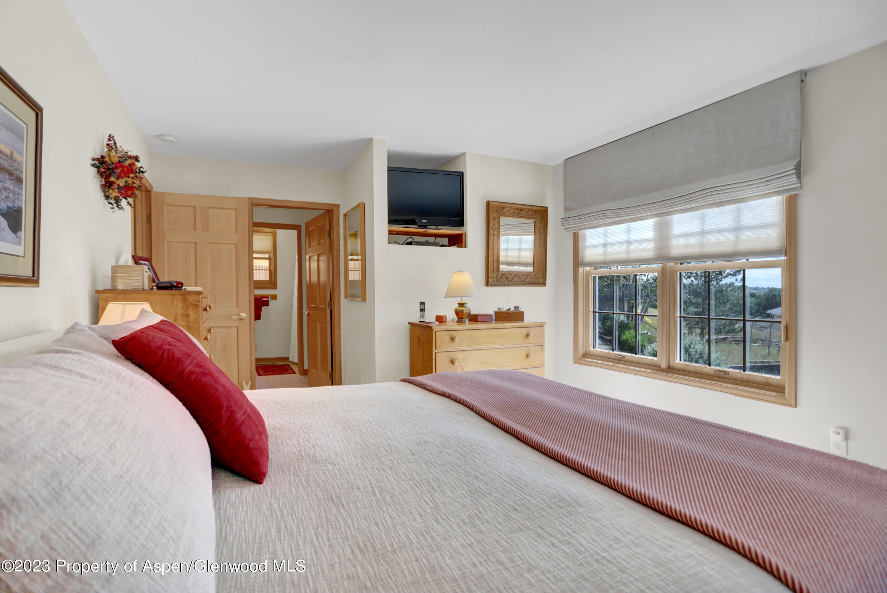 921 Alta Vista Drive Craig, CO 81625 - Photo 37 of 55 a bedroom with a large bed and a flat tv screen