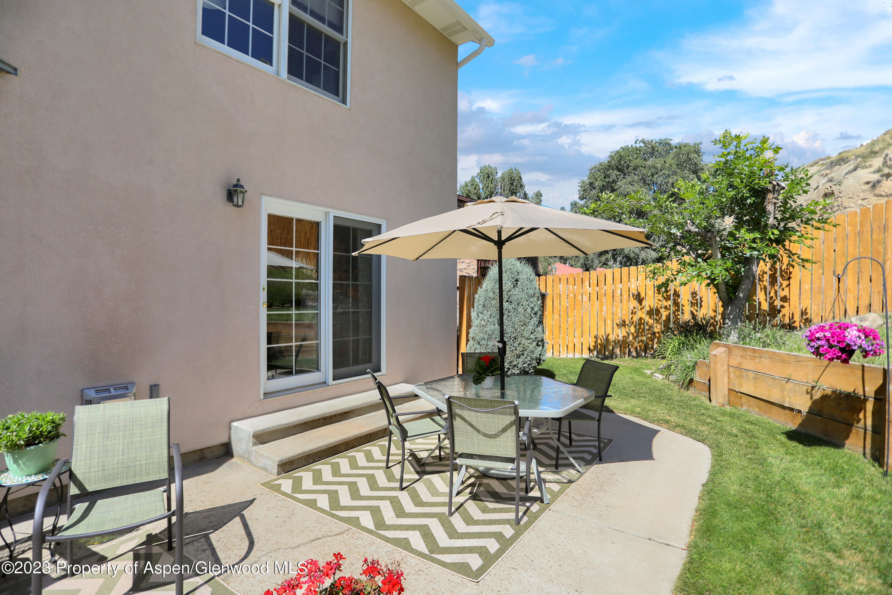 921 Alta Vista Drive Craig, CO 81625 - Photo 52 of 55 a view of a patio with a table and chairs under an umbrella