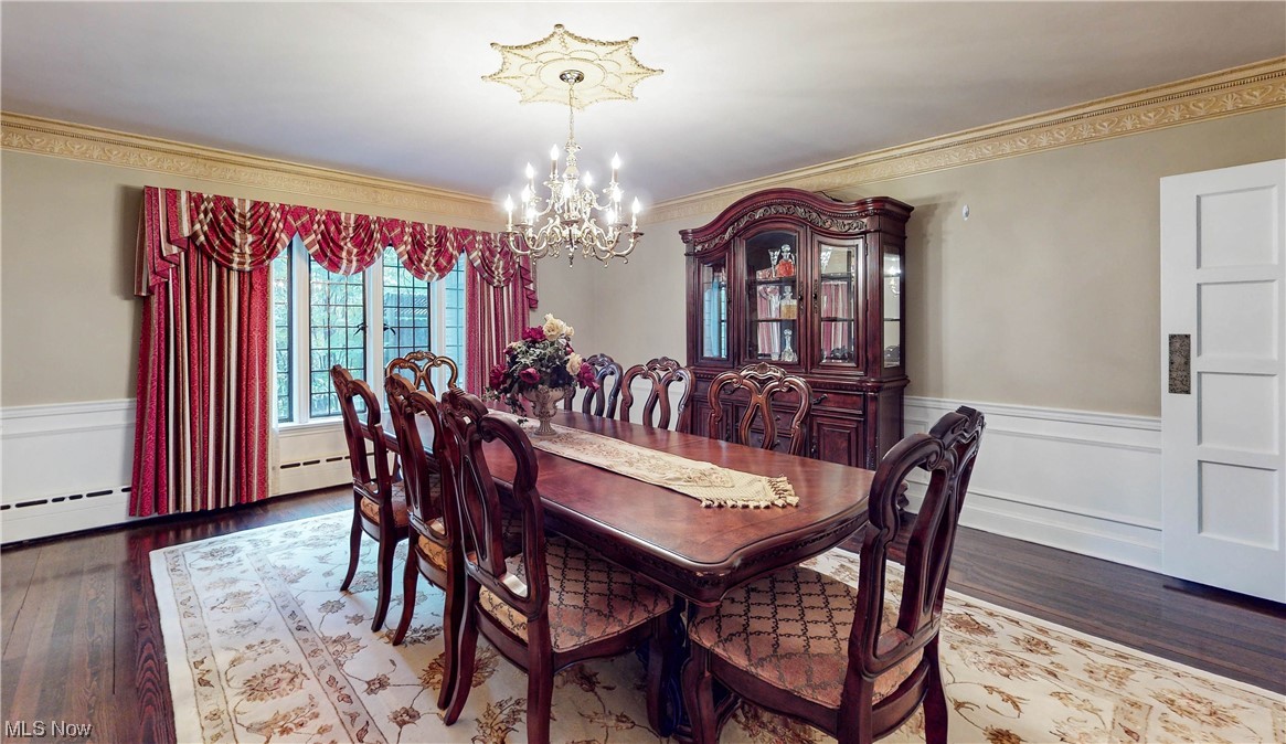 785 Merriman Road Akron, OH 44303 - Photo 9 of 34 Dining area with crown molding, a notable chandelier, and hardwood floors