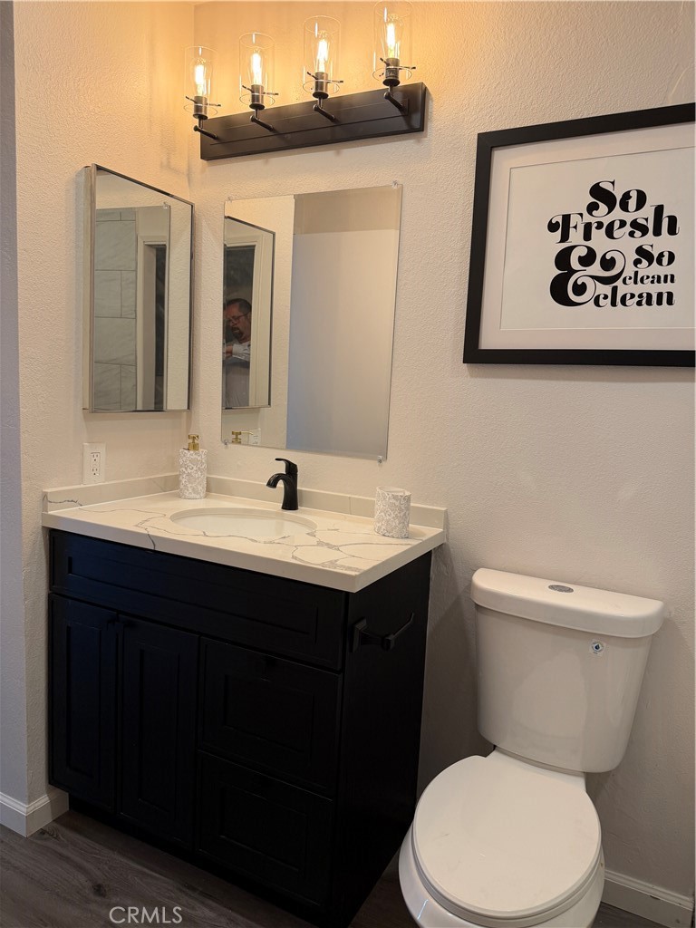 3458 Thunder Drive Oceanside, CA 92056 - Photo 8 of 13 a bathroom with a toilet sink and mirror