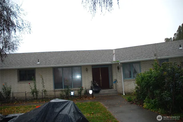 a view of a house with a yard and a garden