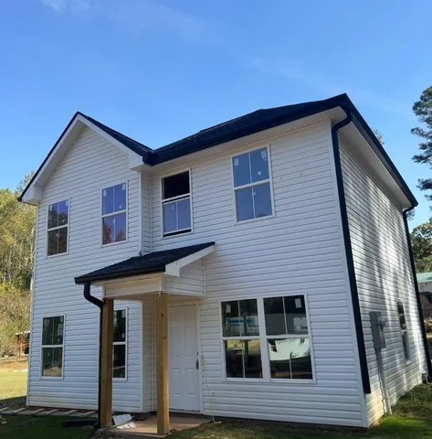 a front view of a house with a yard