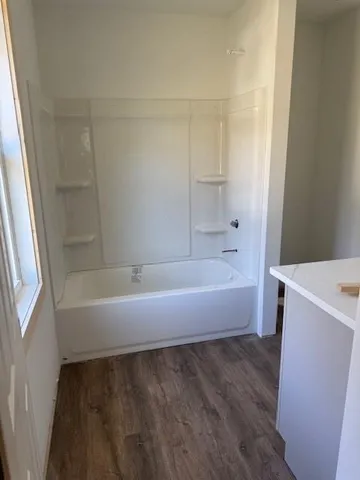 a bathroom with a bathtub and a sink