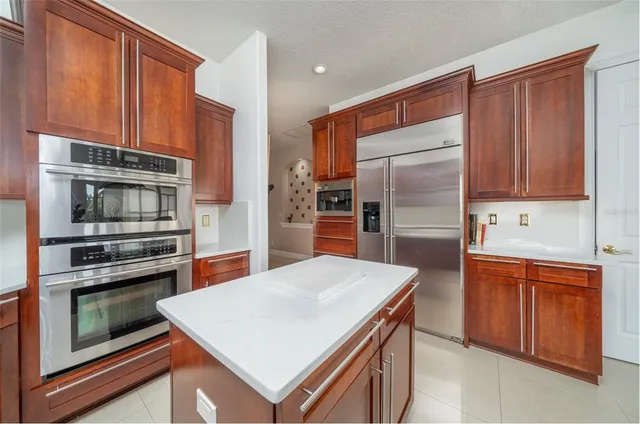 a kitchen with stainless steel appliances a stove sink and refrigerator