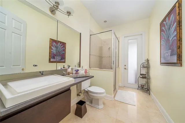 a bathroom with a sink a toilet and shower