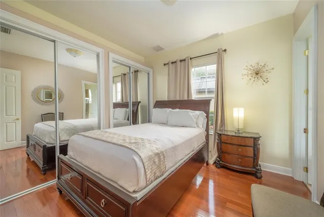 a bedroom with a bed and a mirror