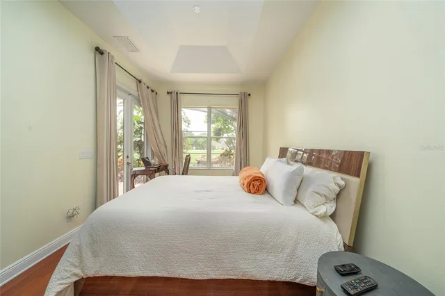 a bedroom with a bed and large window