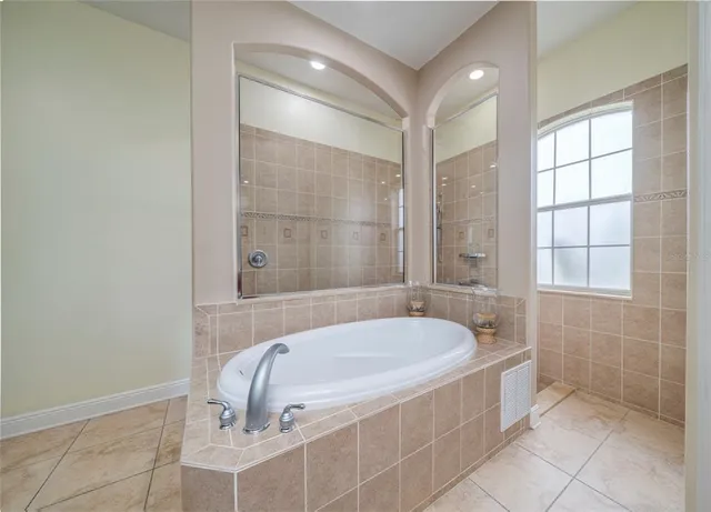 a bathroom with a tub and a shower