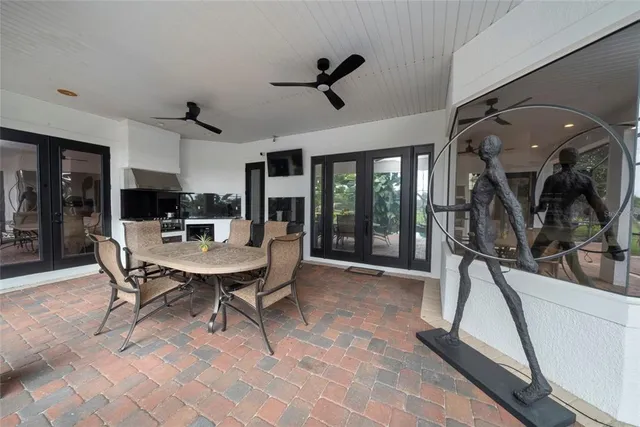 a dining room with furniture a chandelier and window