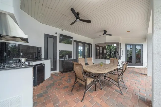 a view of a house with a big yard potted plants and large tree