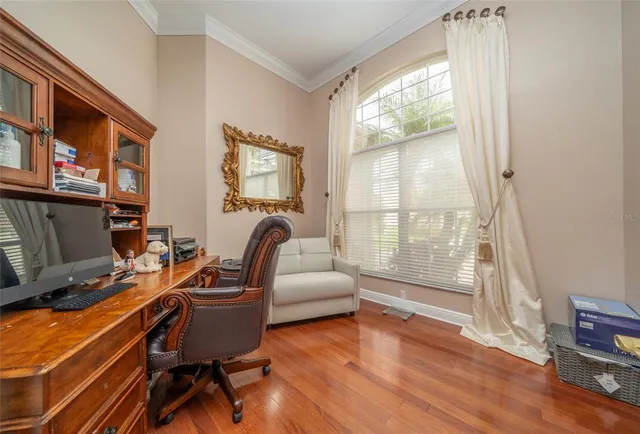 a livingroom with workspace and a window