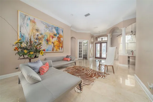 a living room with furniture and flowers