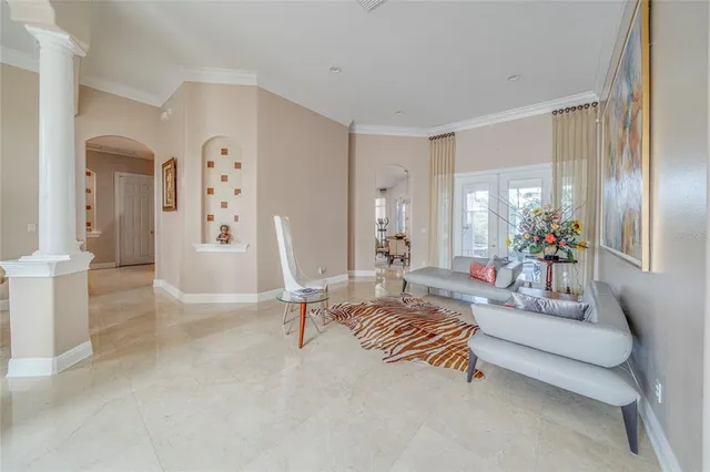 a living room with furniture and a chandelier