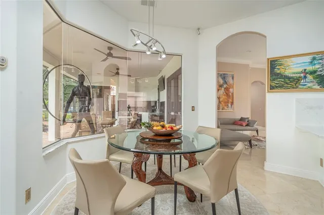 a dining room with furniture a chandelier and wooden floor