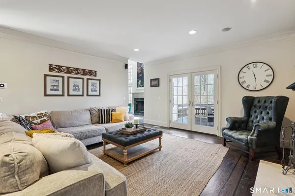 a living room with furniture a table and a large window