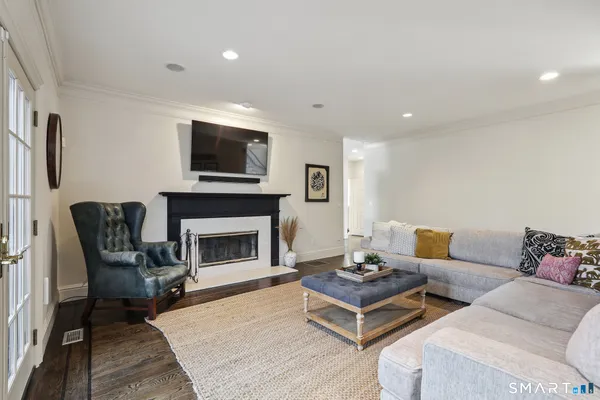 a living room with furniture fireplace and flat screen tv
