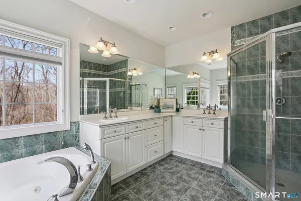 a spacious bathroom with a sink mirror and a bathtub