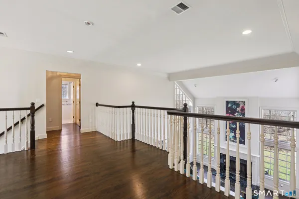 a view of an entryway with wooden floor
