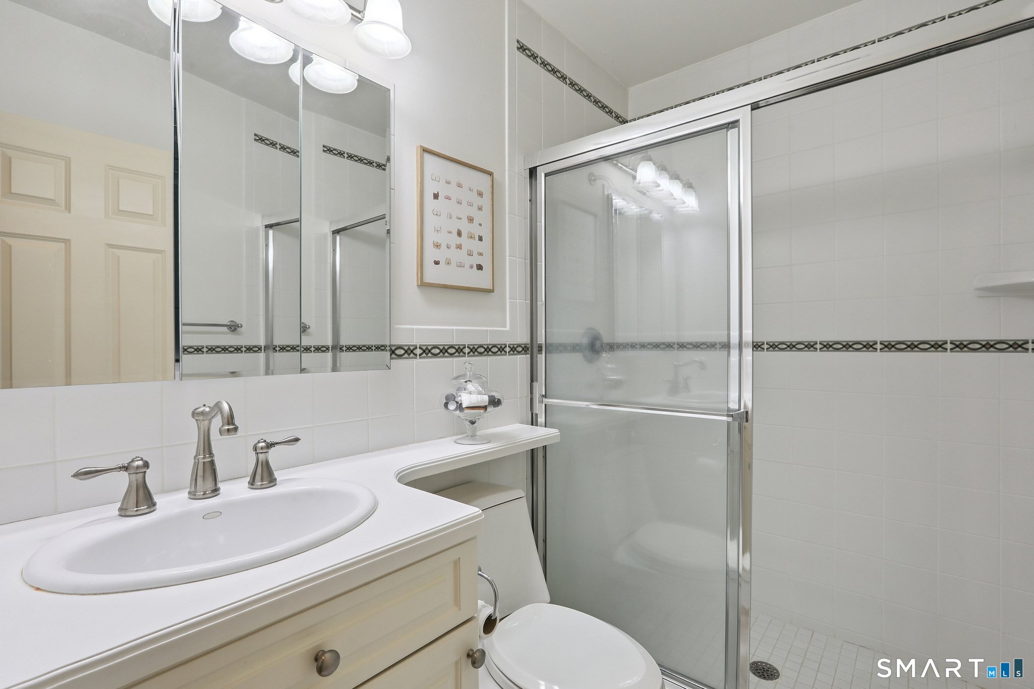 100 Chestnut Hill Road Ridgefield, CT 06877 - Photo 21 of 40 a bathroom with a sink toilet vanity and shower