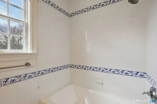 a bathroom with a shower and a window