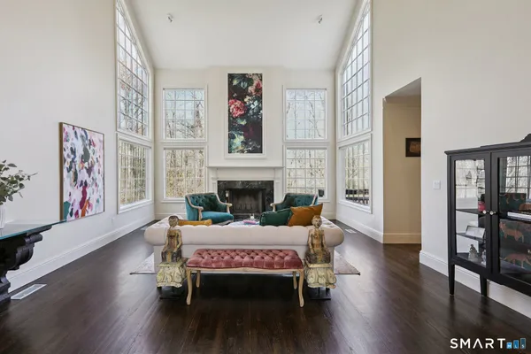 a living room with furniture wooden floor and a fireplace