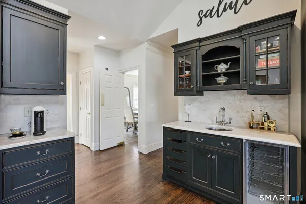 a kitchen with a sink cabinets and wooden floor