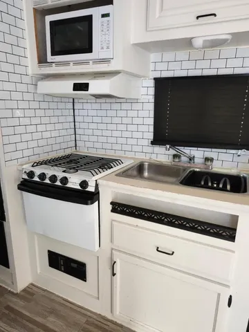 a room with a table chairs and wooden floor