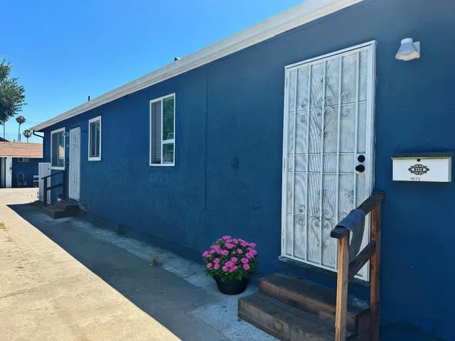 a kitchen with granite countertop white cabinets and black appliances