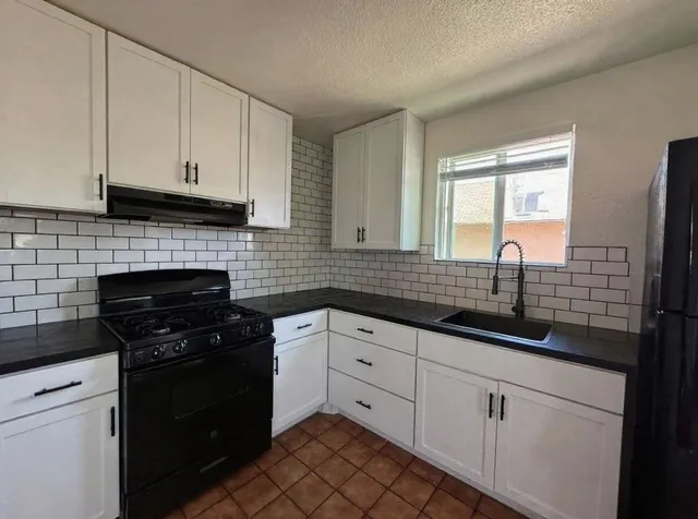 a kitchen with a sink cabinets and a table