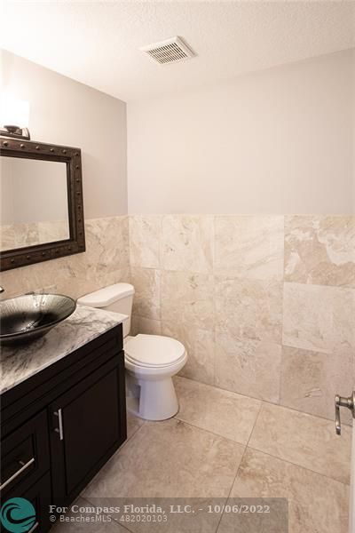 Winston Park Coconut Creek, FL 33073 - Photo 11 of 35 a bathroom with a toilet a sink and mirror